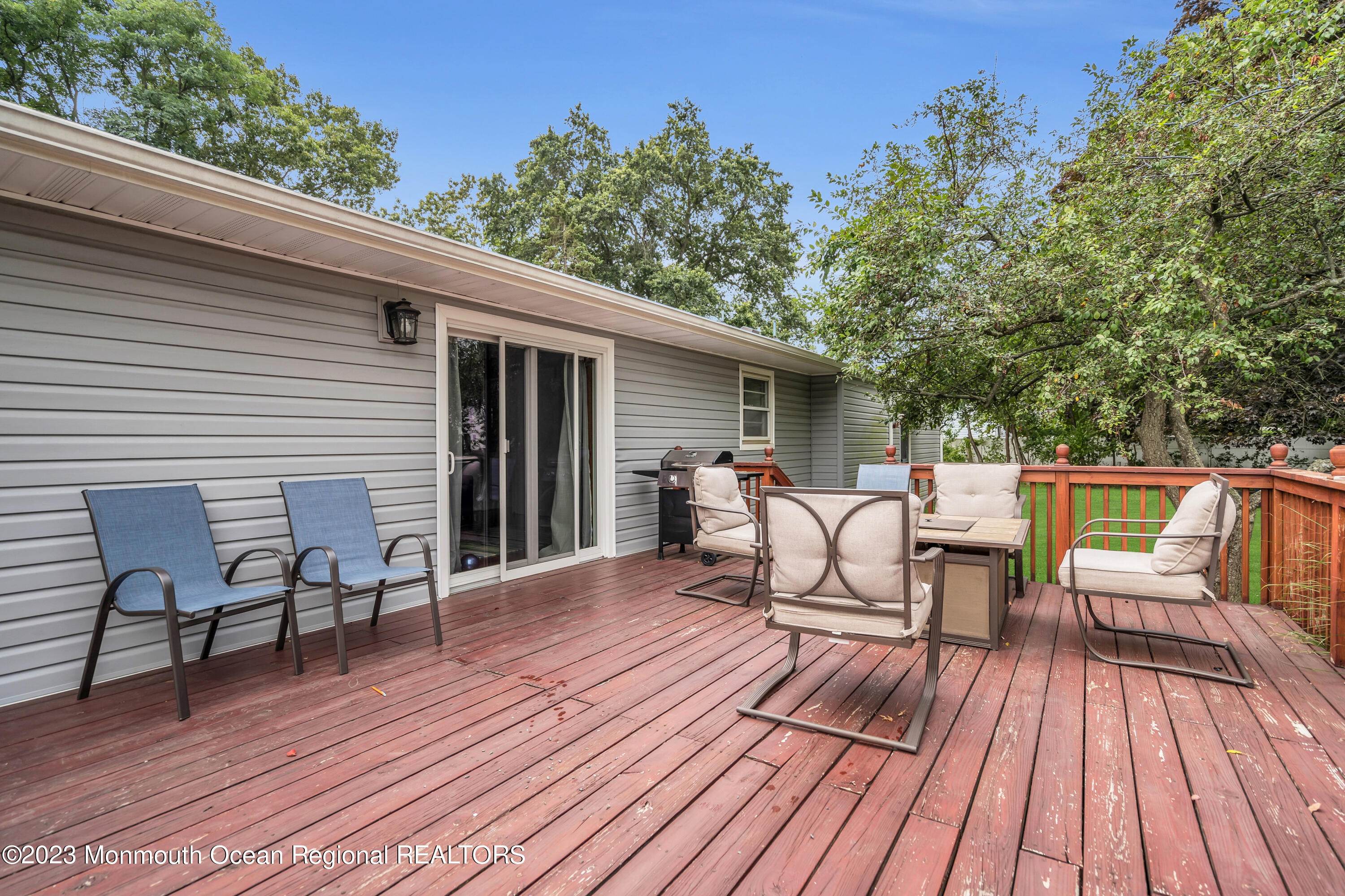 3 Alvord Street Oakhurst, NJ 07755 - Photo 19 of 20 a view of a roof deck with table and chairs floor to ceiling window with wooden floor