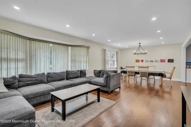 a living room with furniture and view of kitchen