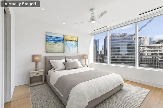 a bedroom with a large bed and a large window