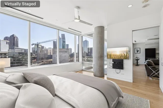 a bedroom with a large bed and a large window