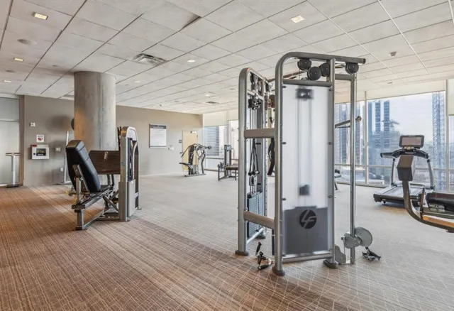 a living room with couches and kitchen view
