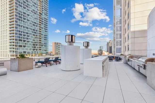 a view of swimming pool with outdoor seating and city view