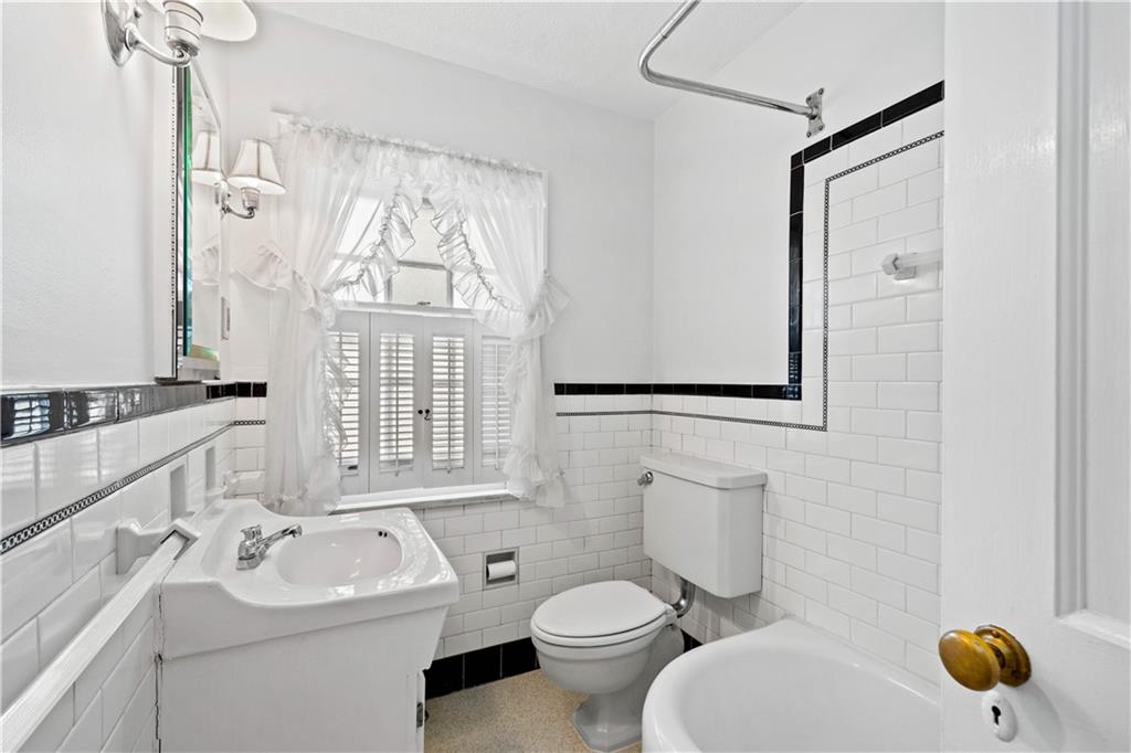 633 Olympia Road Pittsburgh, PA 15211 - Photo 14 of 25 a bathroom with a toilet sink and mirror