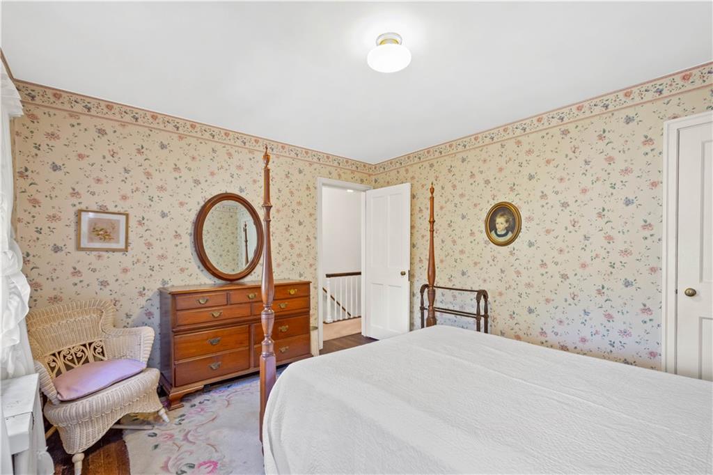 633 Olympia Road Pittsburgh, PA 15211 - Photo 16 of 25 a bedroom with a bed and chair