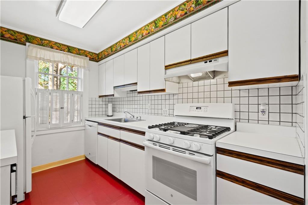 633 Olympia Road Pittsburgh, PA 15211 - Photo 10 of 25 a kitchen with stainless steel appliances a stove a sink and a microwave