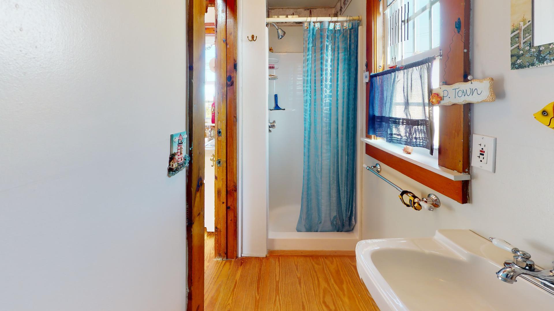 334 Shore Road, Unit 11 Truro, MA 02666 - Photo 15 of 26 a bathroom with a sink and a mirror
