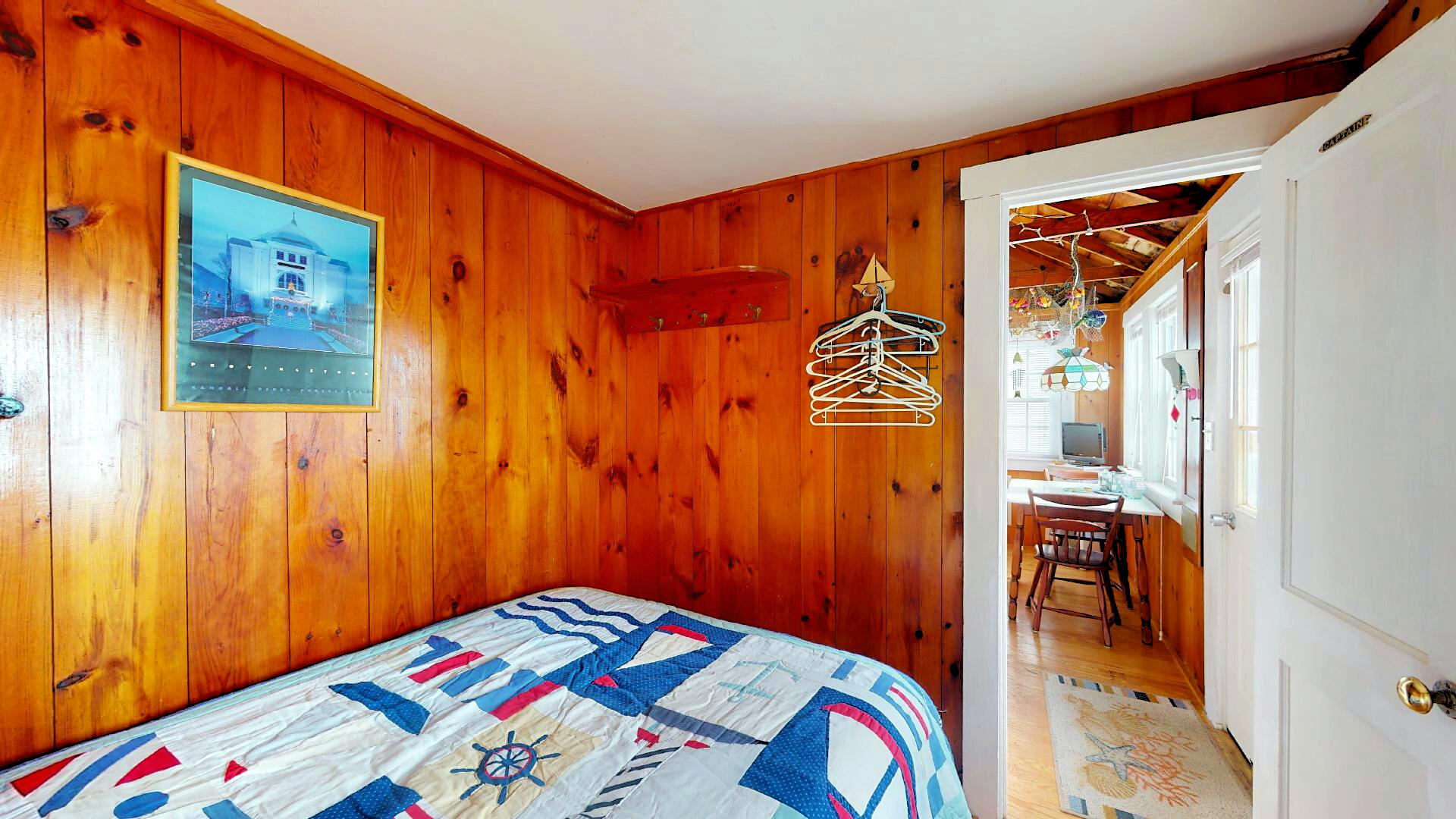 334 Shore Road, Unit 11 Truro, MA 02666 - Photo 20 of 26 a bedroom with a bed and a painting on the wall