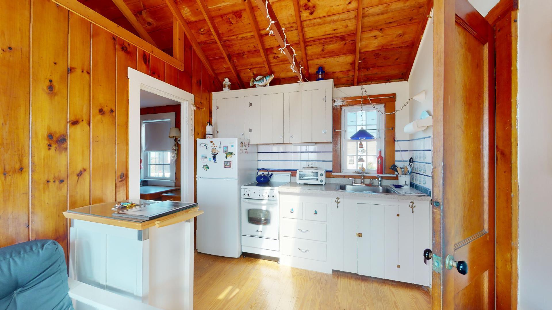 334 Shore Road, Unit 11 Truro, MA 02666 - Photo 4 of 26 a kitchen with stainless steel appliances granite countertop a sink and cabinets