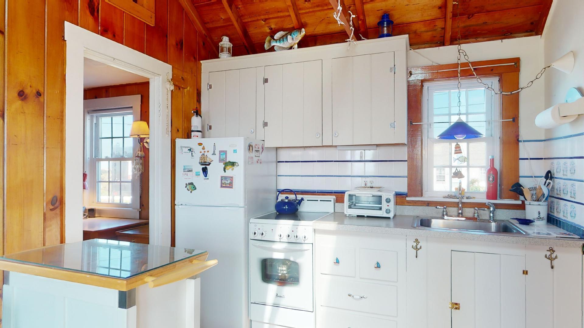 334 Shore Road, Unit 11 Truro, MA 02666 - Photo 5 of 26 a kitchen with stainless steel appliances cabinets and a window