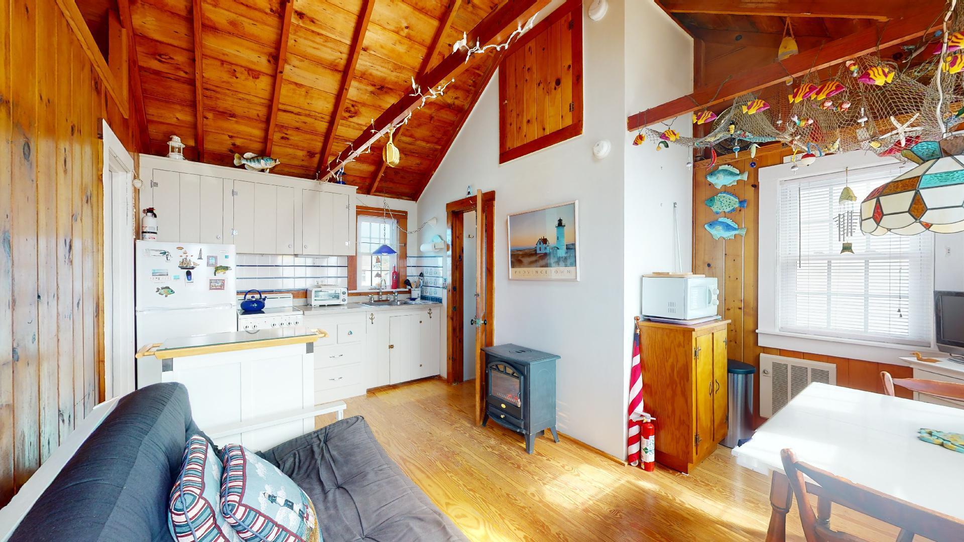334 Shore Road, Unit 11 Truro, MA 02666 - Photo 8 of 26 a view of a kitchen with furniture and wooden floor