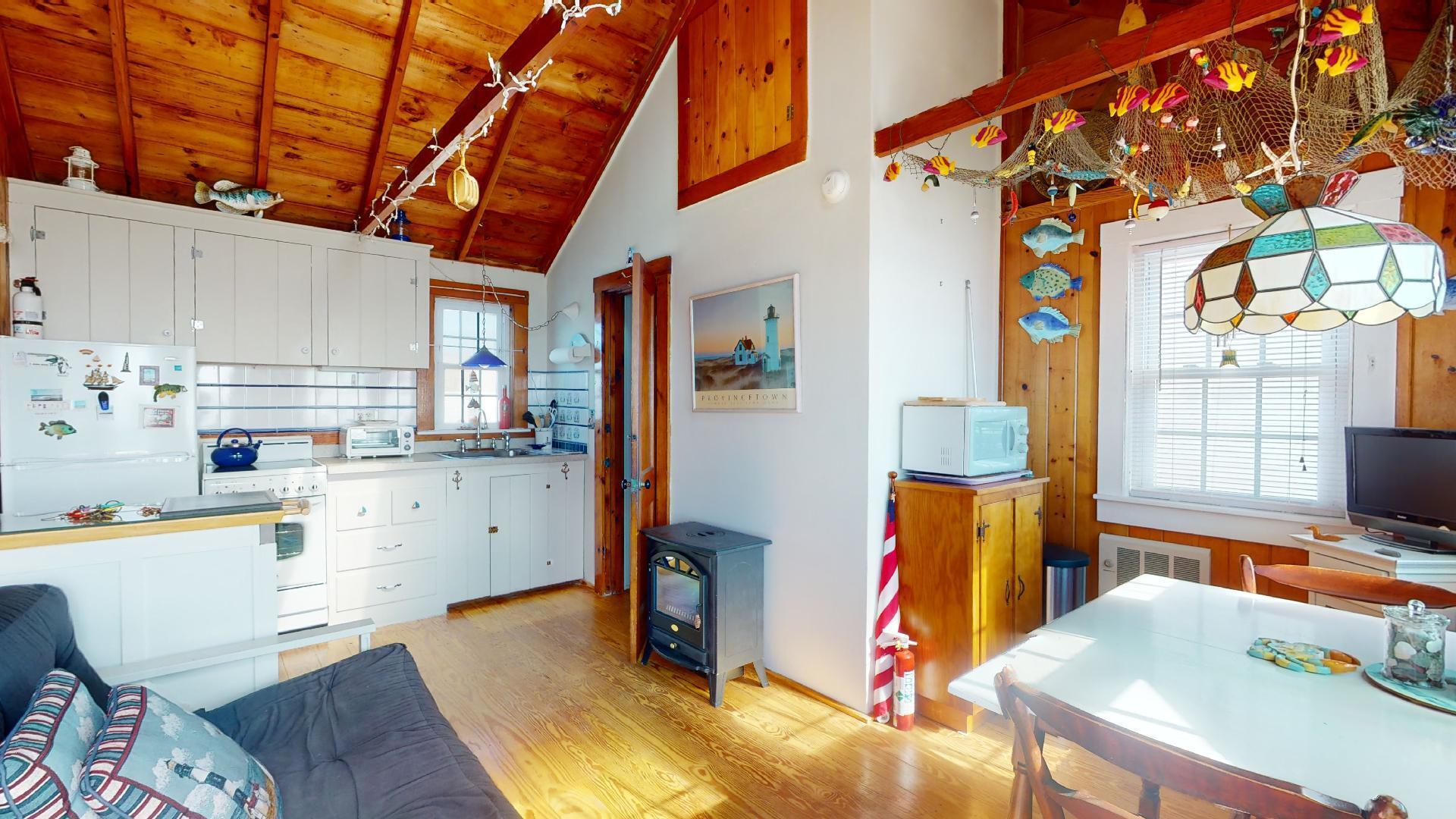334 Shore Road, Unit 11 Truro, MA 02666 - Photo 10 of 26 a view of a kitchen with fridge and workspace