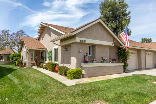 a front view of a house with a yard and porch
