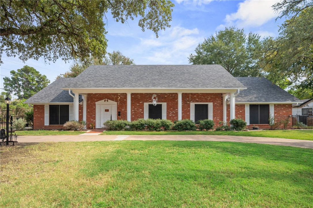 503 Calvert Street Hearne, TX 77859 - Photo 1 of 30 View of front of property featuring a porch, brick siding, and a shingled roof