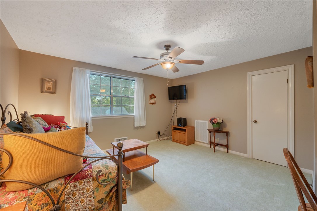503 Calvert Street Hearne, TX 77859 - Photo 15 of 30 Sitting room featuring carpet, a ceiling fan, and a textured ceiling