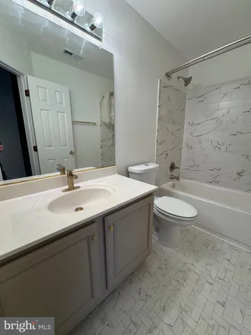 a bathroom with a double vanity sink toilet and shower