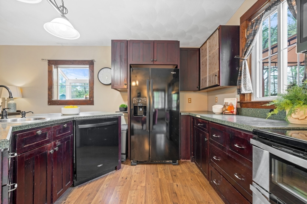 44 Shawsheen Road Billerica, MA 01821 - Photo 13 of 39 a kitchen with stainless steel appliances granite countertop a refrigerator and a stove top oven