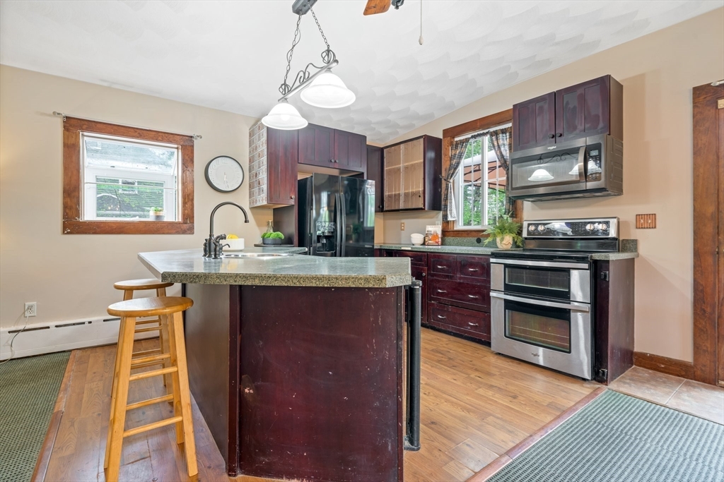 44 Shawsheen Road Billerica, MA 01821 - Photo 14 of 39 a kitchen with kitchen island granite countertop a stove and a sink
