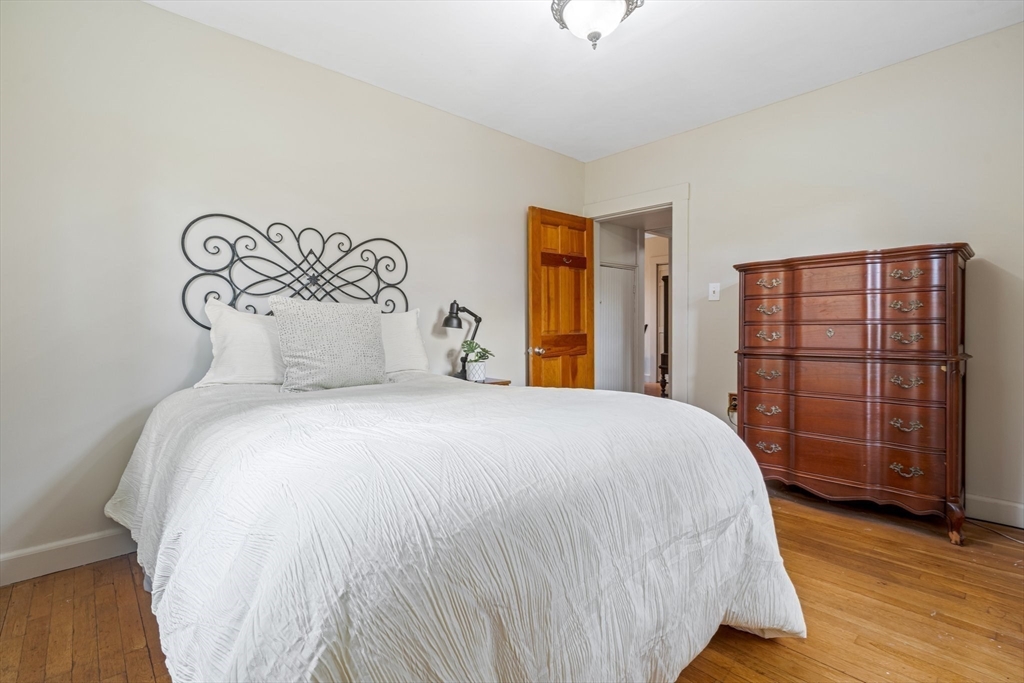 44 Shawsheen Road Billerica, MA 01821 - Photo 23 of 39 a bedroom with a large bed and wooden floor