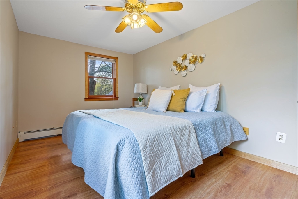 44 Shawsheen Road Billerica, MA 01821 - Photo 27 of 39 a bedroom with a bed and a chandelier
