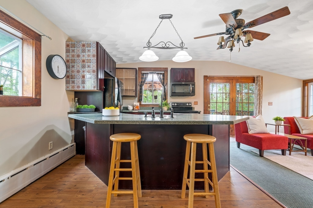 44 Shawsheen Road Billerica, MA 01821 - Photo 10 of 39 a kitchen with a dining table chairs cabinets and stainless steel appliances