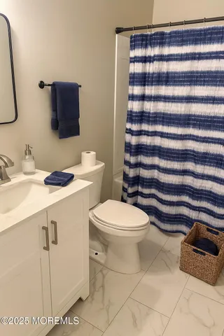 a bathroom with a sink toilet and mirror