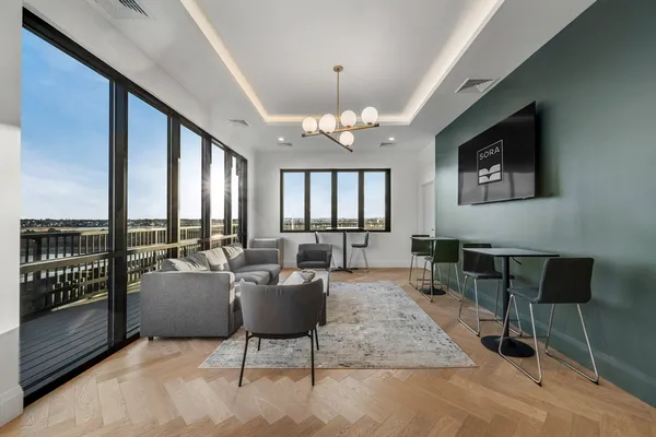 a living room with furniture and a chandelier