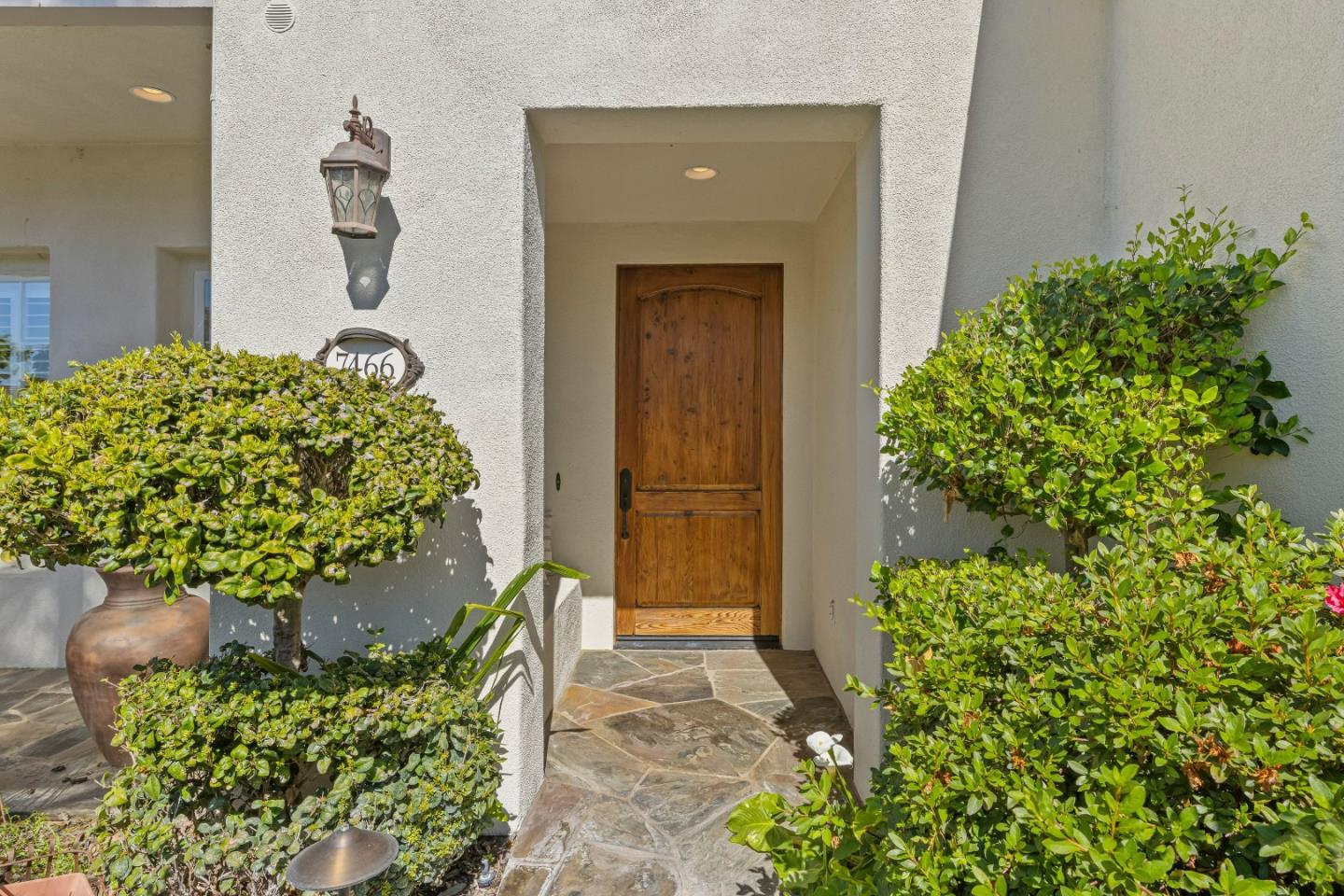 7466 Dunbar Court Gilroy, CA 95020 - Photo 5 of 103 a front view of a house with a yard and flowers
