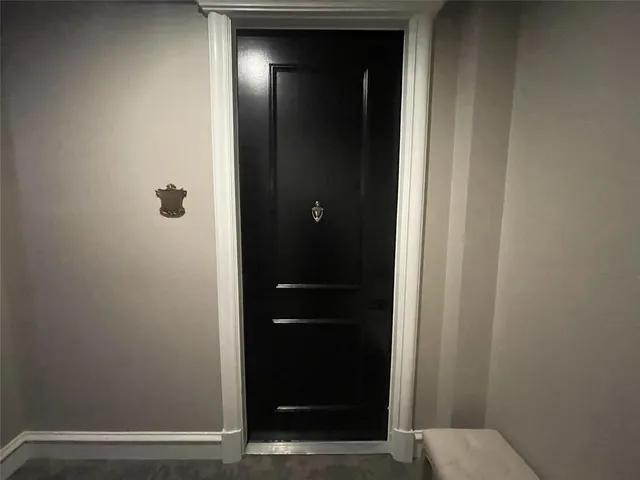 a bathroom with a toilet and a mirror