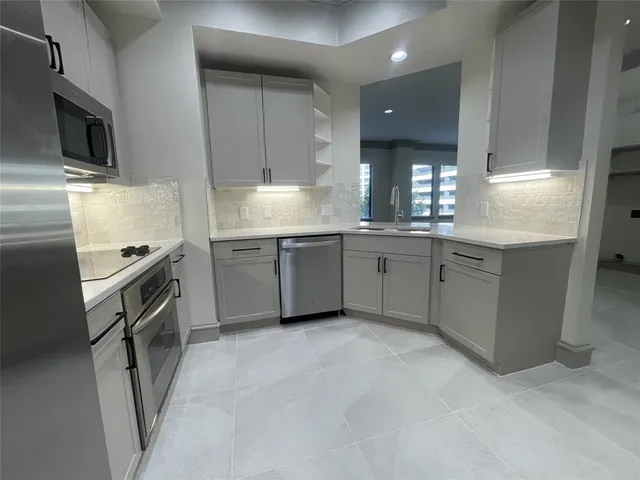 a kitchen with a stove microwave and refrigerator