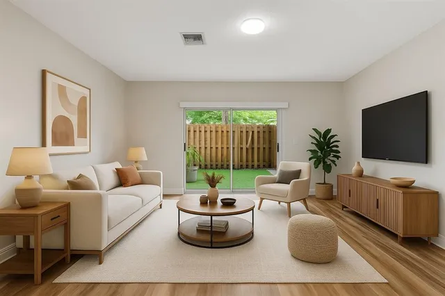 a living room with furniture a flat screen tv and a large window
