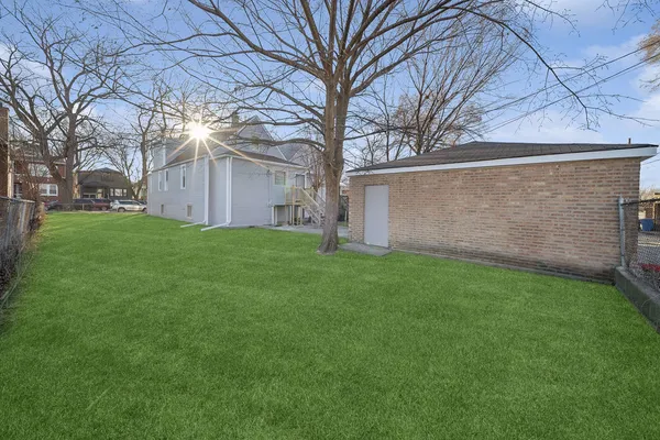 a view of a backyard with a large tree