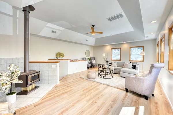 a living room with furniture and a chandelier