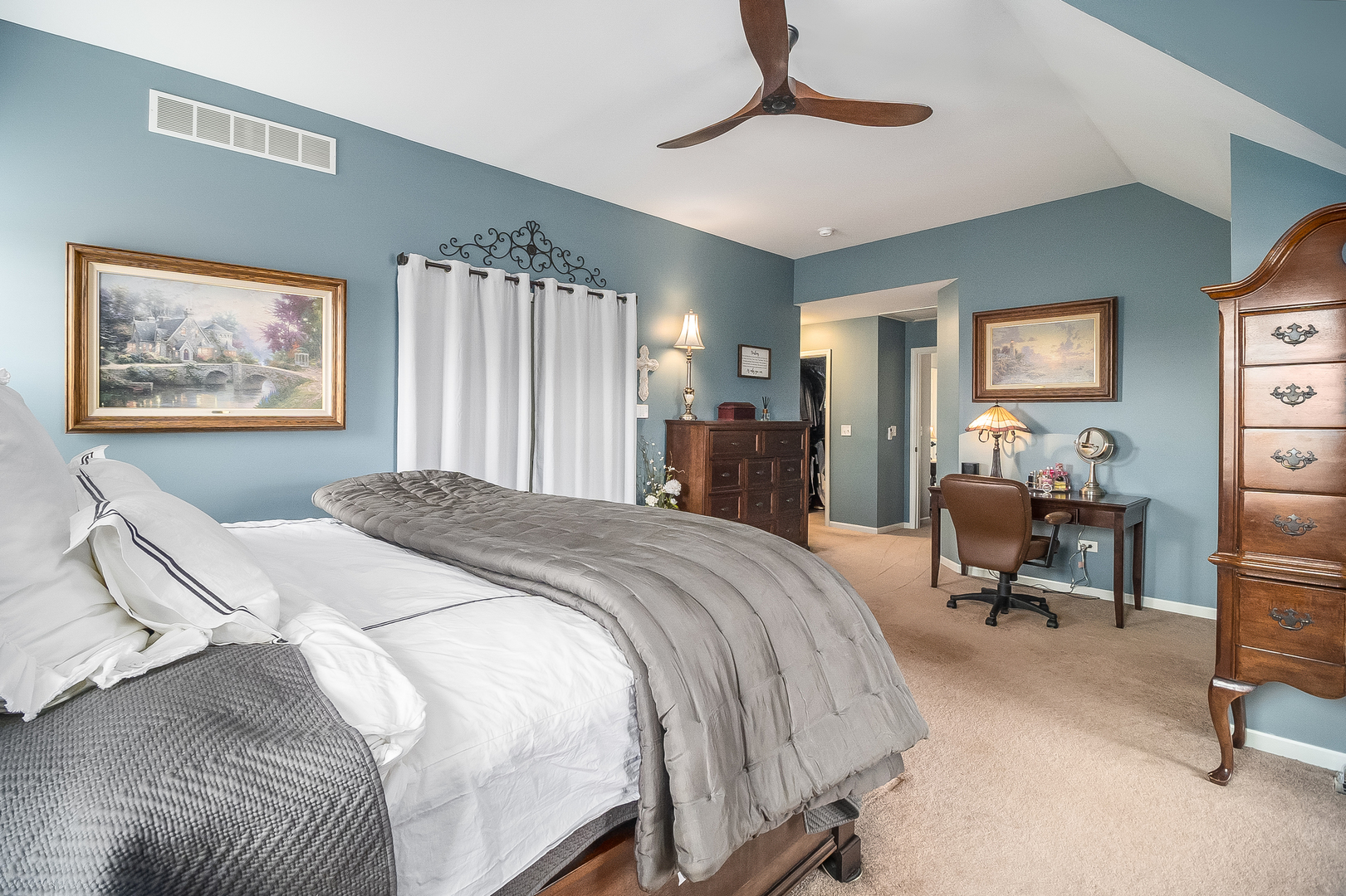 13130 Sunderlin Road Plainfield, IL 60585 - Photo 15 of 33 a bedroom with a bed and a chandelier