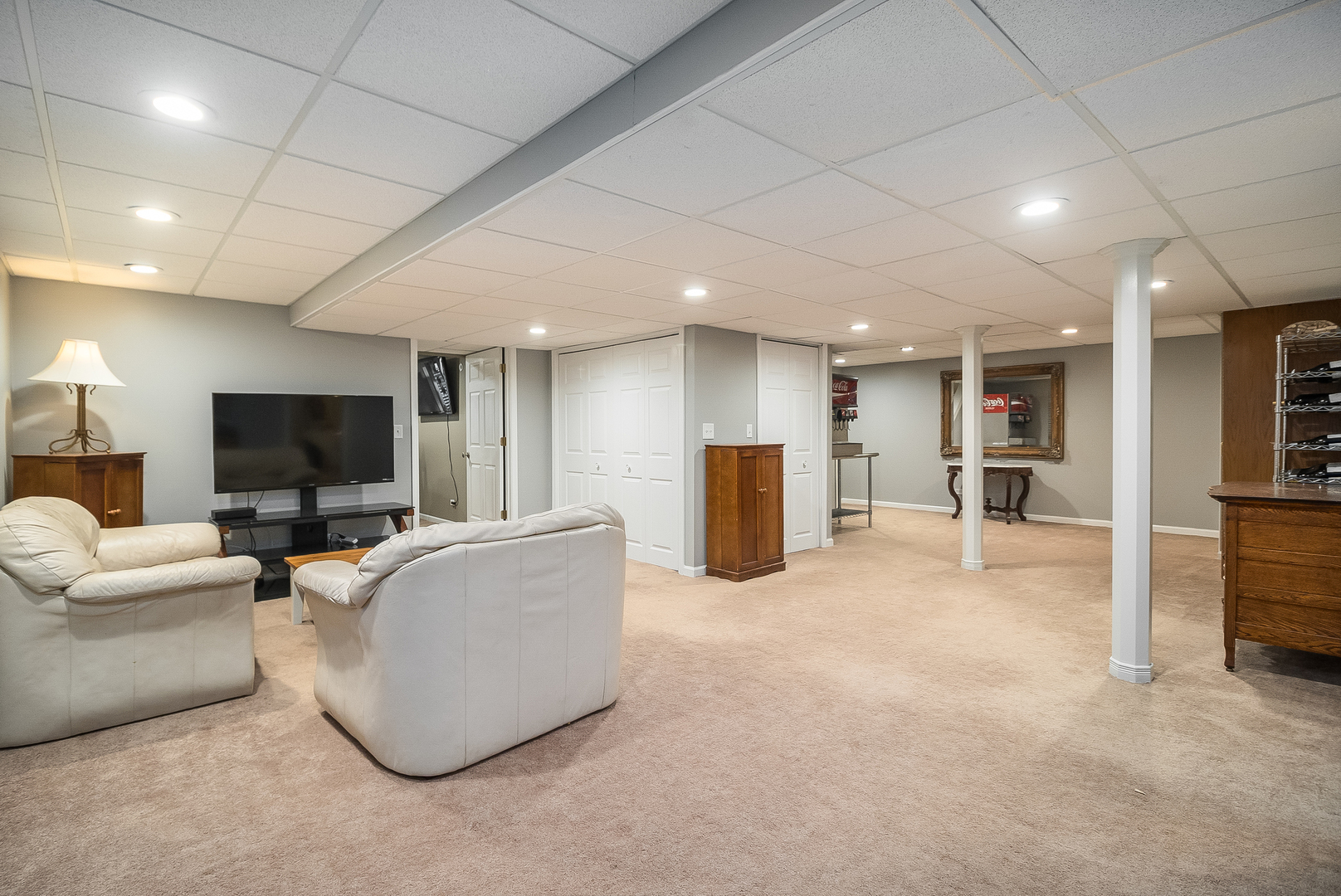 13130 Sunderlin Road Plainfield, IL 60585 - Photo 22 of 33 a living room with furniture and a flat screen tv