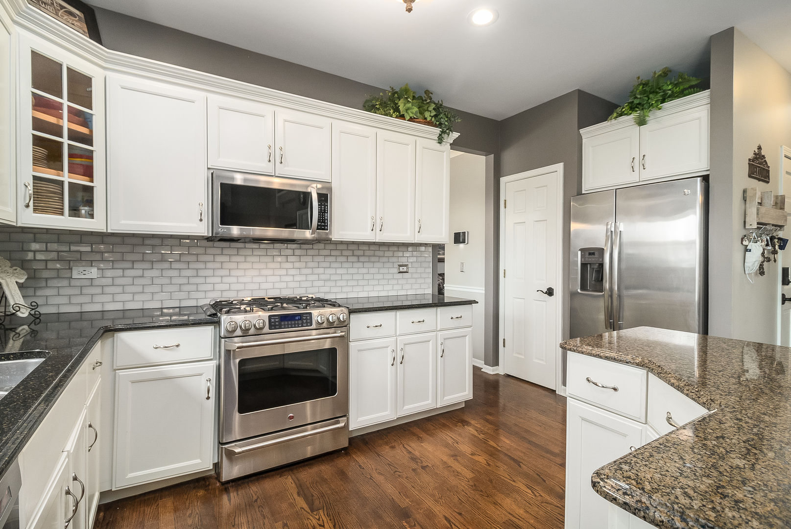 13130 Sunderlin Road Plainfield, IL 60585 - Photo 6 of 33 a kitchen with stainless steel appliances granite countertop a stove a sink and a microwave