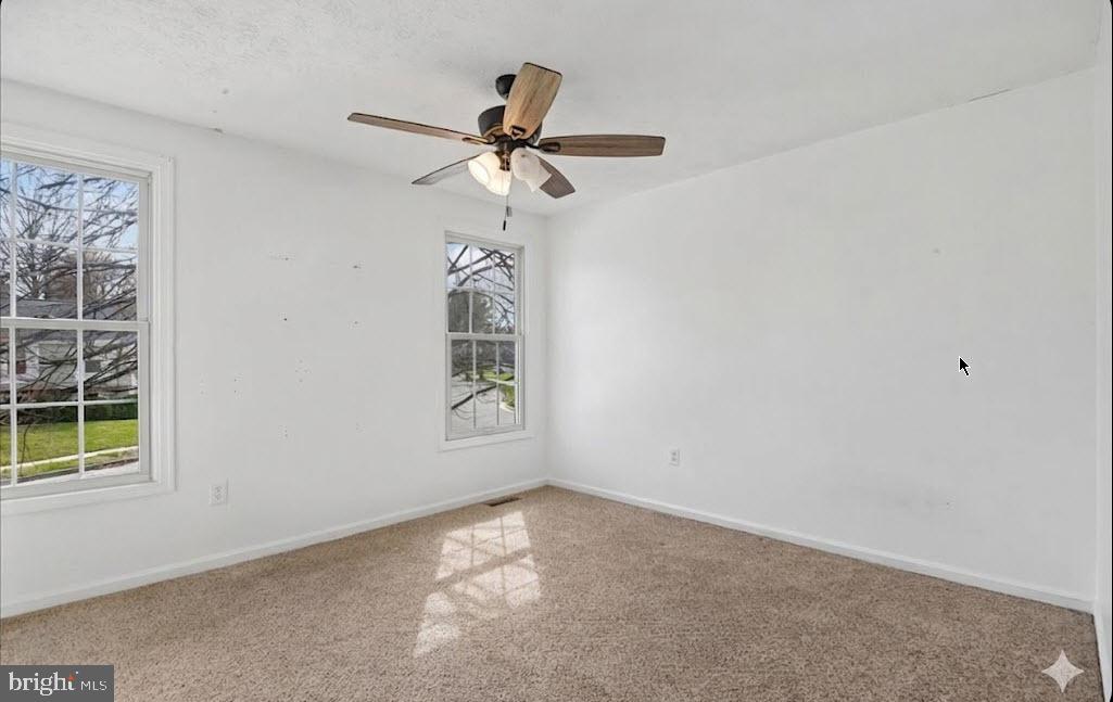 6413 White Peach Place Columbia, MD 21045 - Photo 13 of 31 an empty room with windows and fan