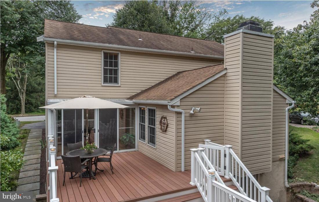 6413 White Peach Place Columbia, MD 21045 - Photo 19 of 31 a view of a house with wooden deck and furniture