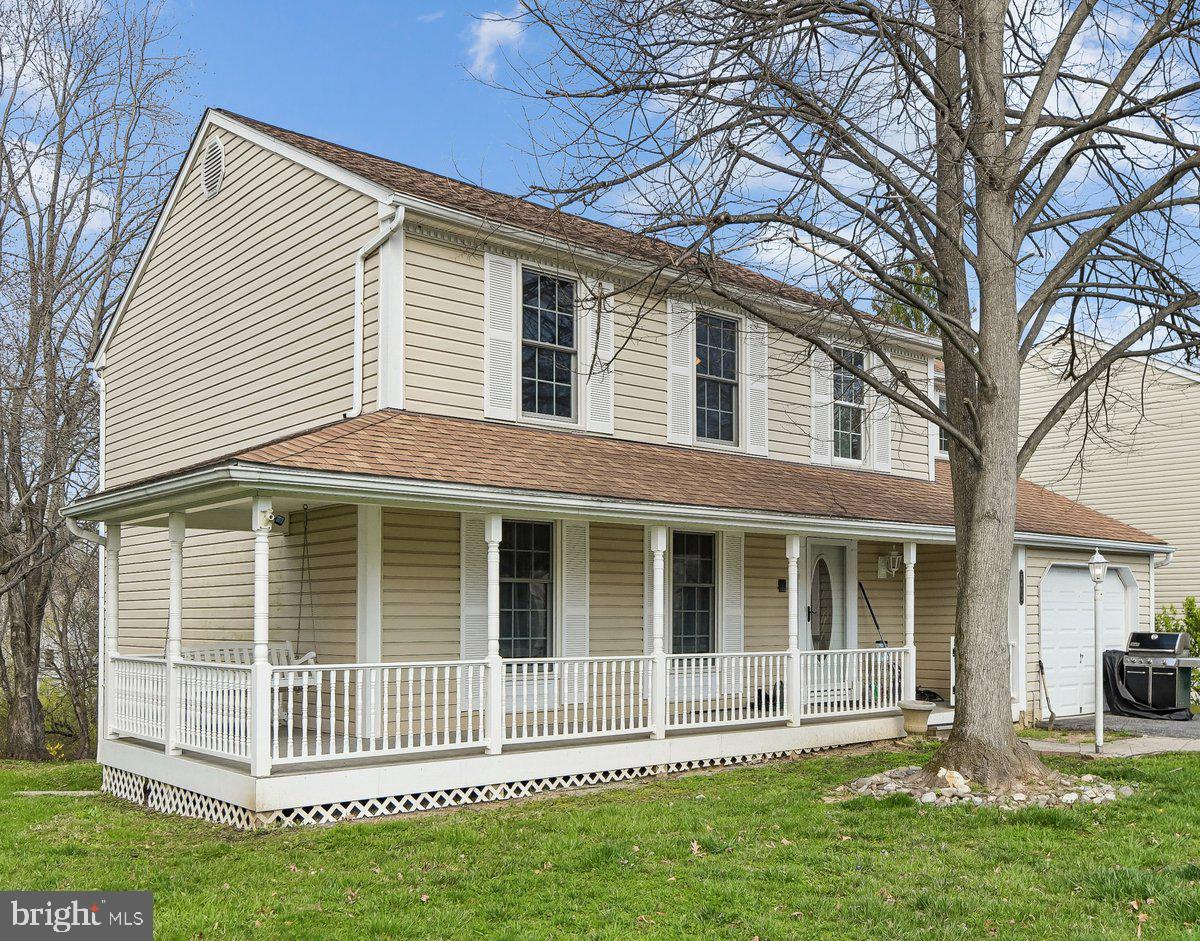 6413 White Peach Place Columbia, MD 21045 - Photo 2 of 31 a front view of a house with a yard