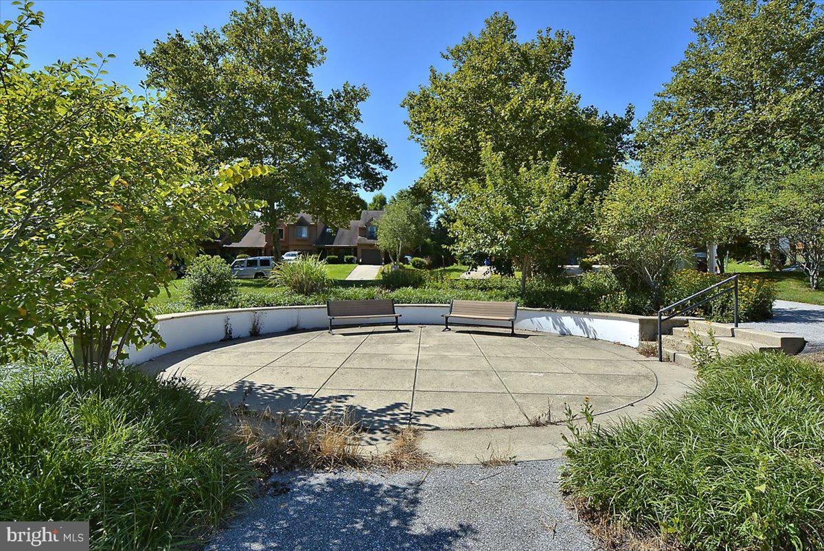 6413 White Peach Place Columbia, MD 21045 - Photo 29 of 31 a view of a swimming pool with an outdoor space and seating area