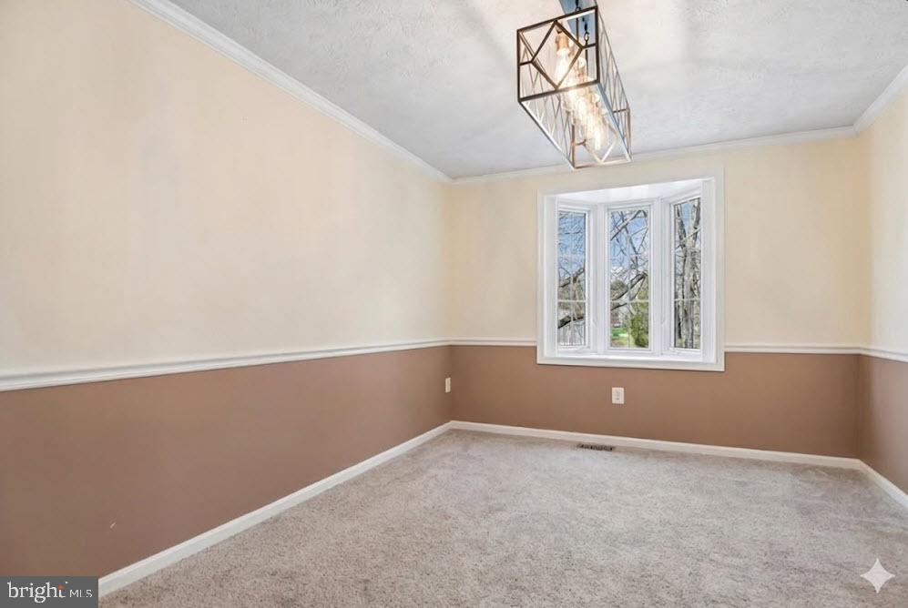 6413 White Peach Place Columbia, MD 21045 - Photo 6 of 31 an empty room with windows and chandelier
