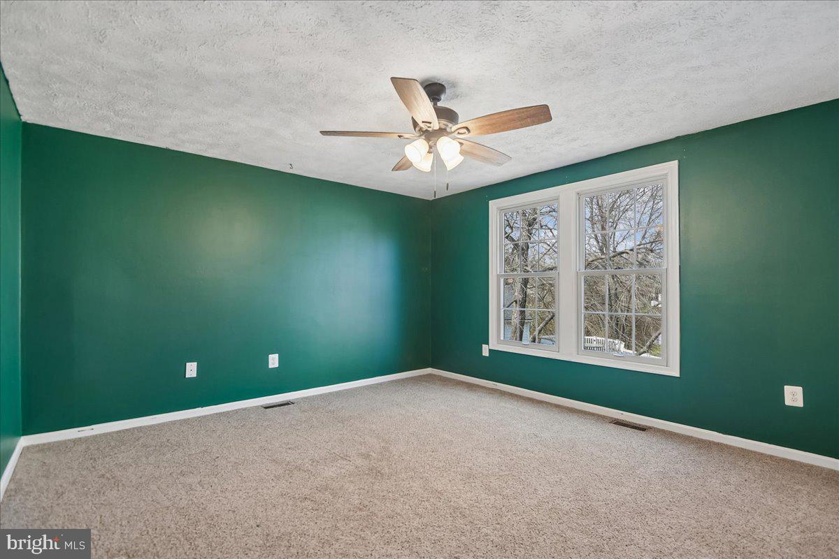 6413 White Peach Place Columbia, MD 21045 - Photo 10 of 31 an empty room with a window and a ceiling fan