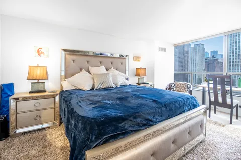 a bedroom with a large bed and a flat screen tv