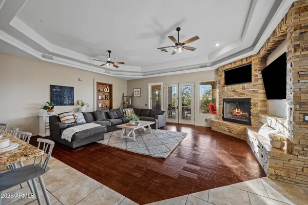 a kitchen with stainless steel appliances granite countertop a sink a stove and a wooden floors