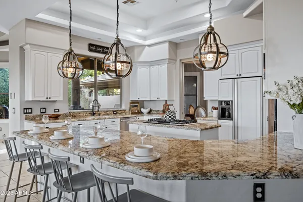 a kitchen with appliances a sink and cabinets