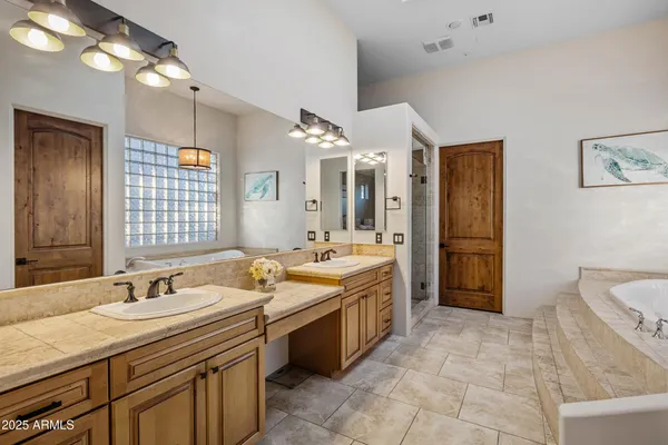 a kitchen with stainless steel appliances granite countertop a sink and a stove next to a window