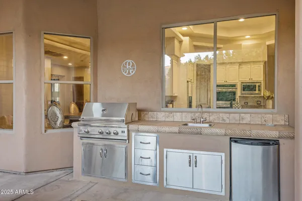 a backyard of a house with a table and chairs