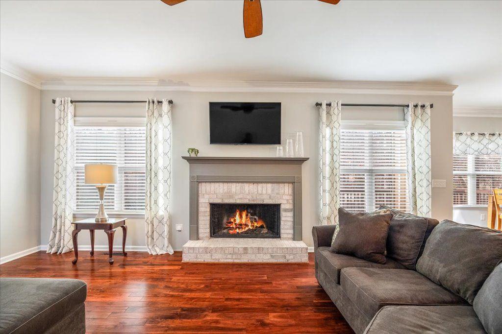 4965 Cheltenham Place Cumming, GA 30041 - Photo 11 of 47 a living room with furniture window and a fireplace