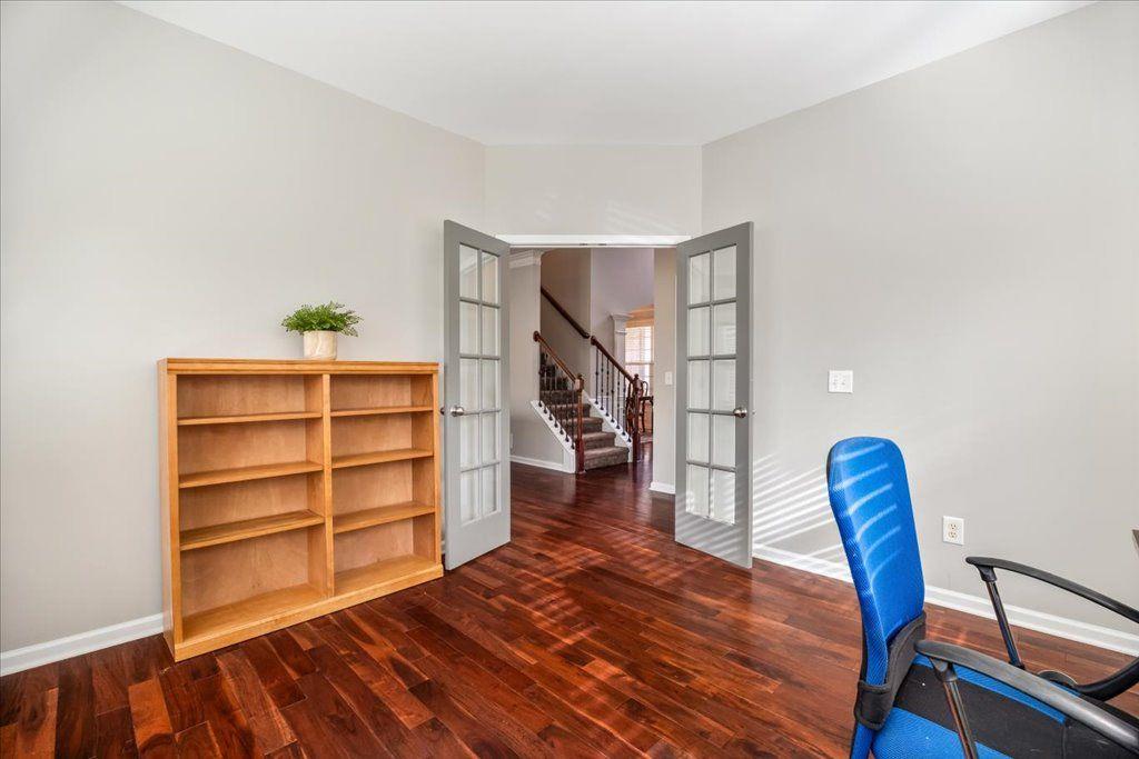 4965 Cheltenham Place Cumming, GA 30041 - Photo 13 of 47 a view of room with wooden floor and stairs
