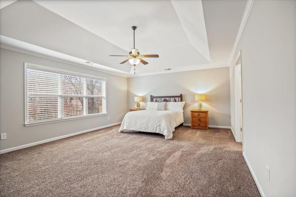 4965 Cheltenham Place Cumming, GA 30041 - Photo 15 of 47 a spacious bedroom with a bed and a window