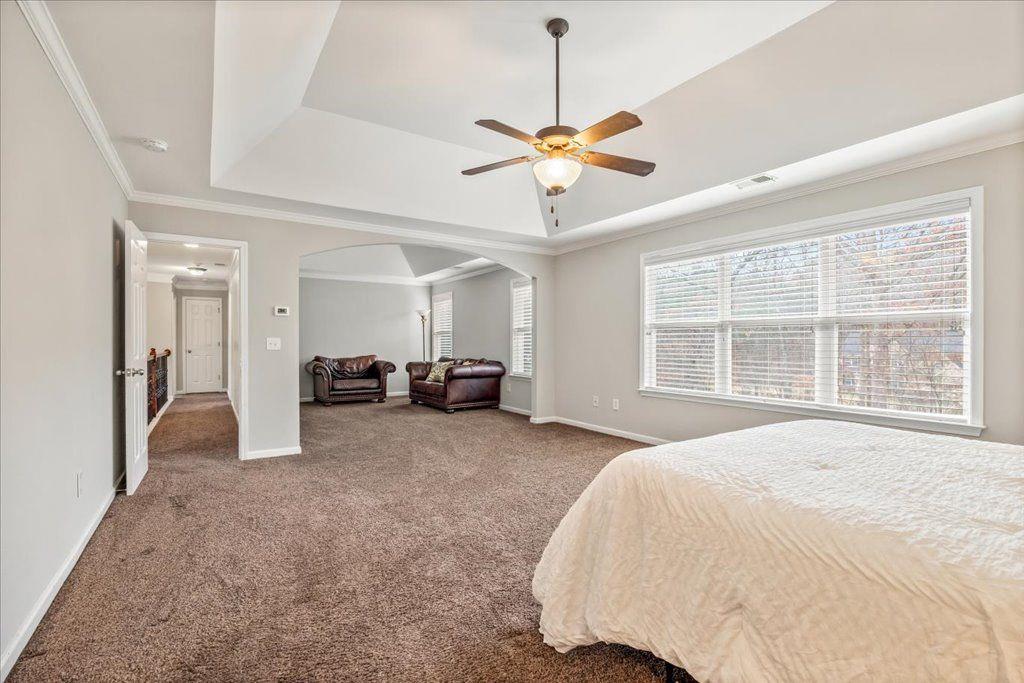4965 Cheltenham Place Cumming, GA 30041 - Photo 16 of 47 a spacious bedroom with a bed and ceiling fan